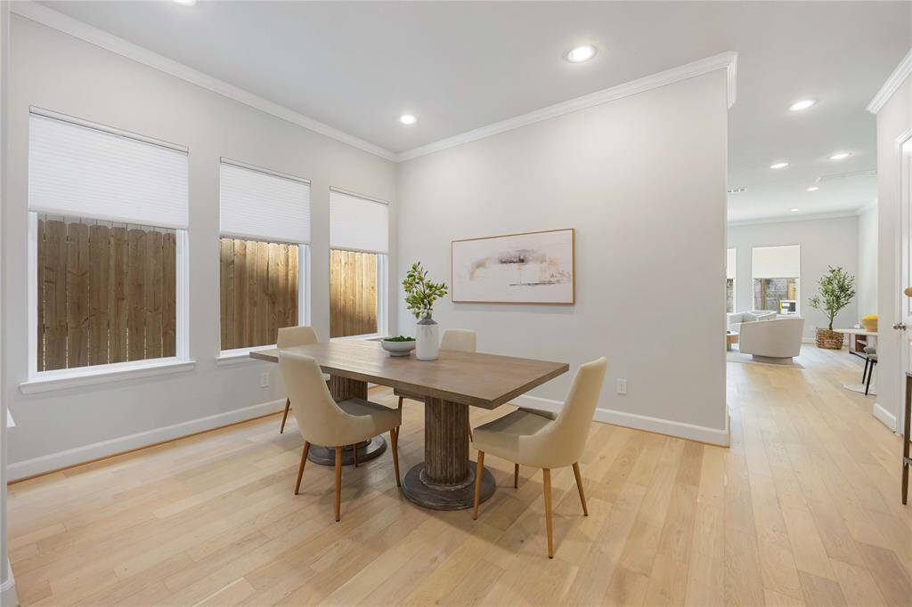 Dine under the soft embrace of daylight, with a wall of windows inviting the outside in.