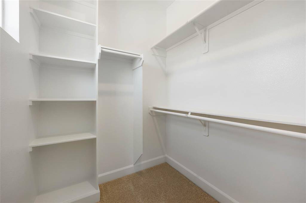 Discover custom shelving in the closet of this second-floor bedroom.