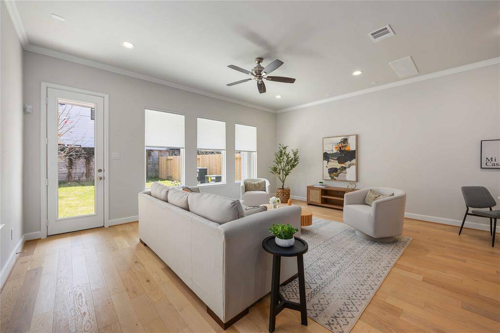 Recessed lighting and a sleek ceiling fan create a warm, inviting ambiance—perfect for unwinding in the comfort of your spacious living room.
