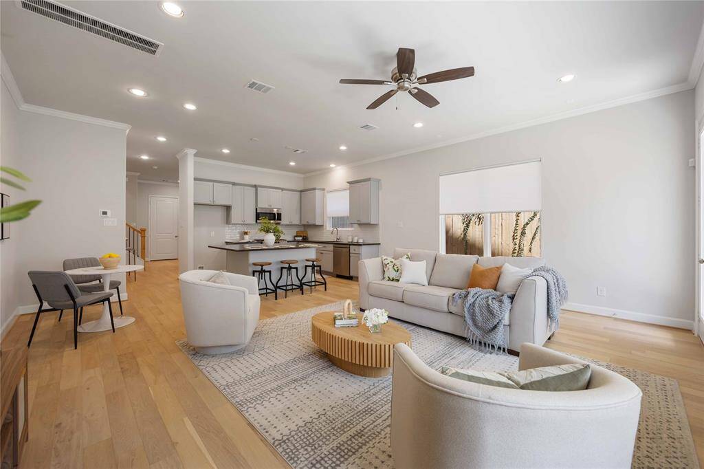The living space seamlessly flows into the kitchen and dining areas, perfect for entertaining.