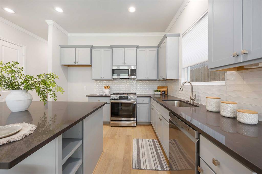 The kitchen is a chef’s dream, featuring a generous island, expansive quartz countertops, and plenty of room to cook side by side with ease. Thoughtful touches like soft-close drawers and a built-in waste bin pull-out elevate both functionality and luxury.