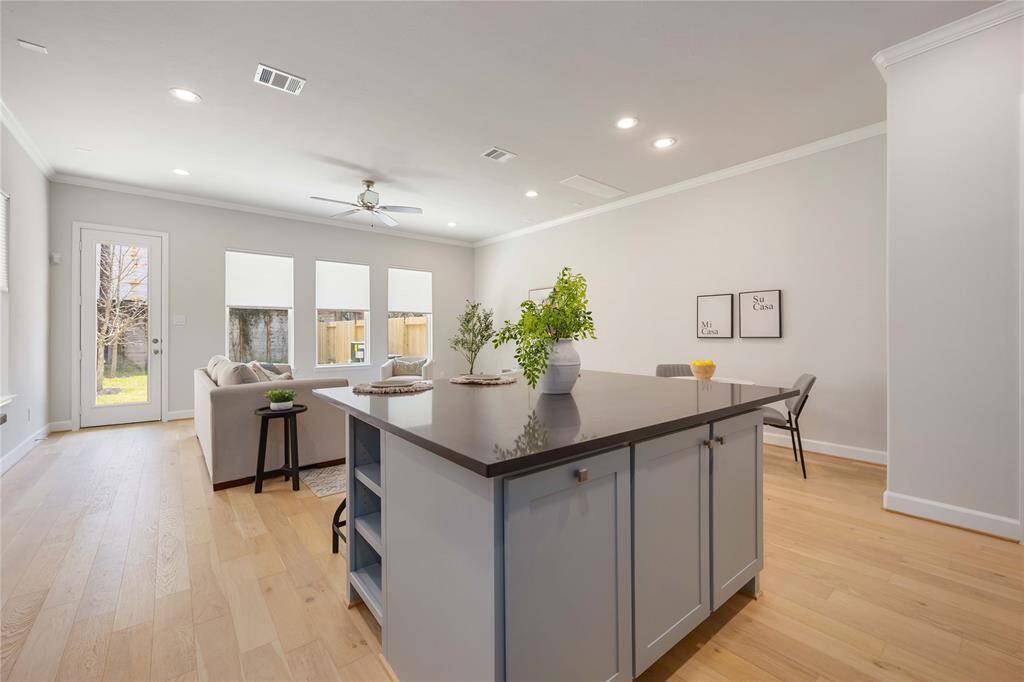 In the kitchen, rich, durable dark quartz countertops create a striking contrast against sleek cabinetry.