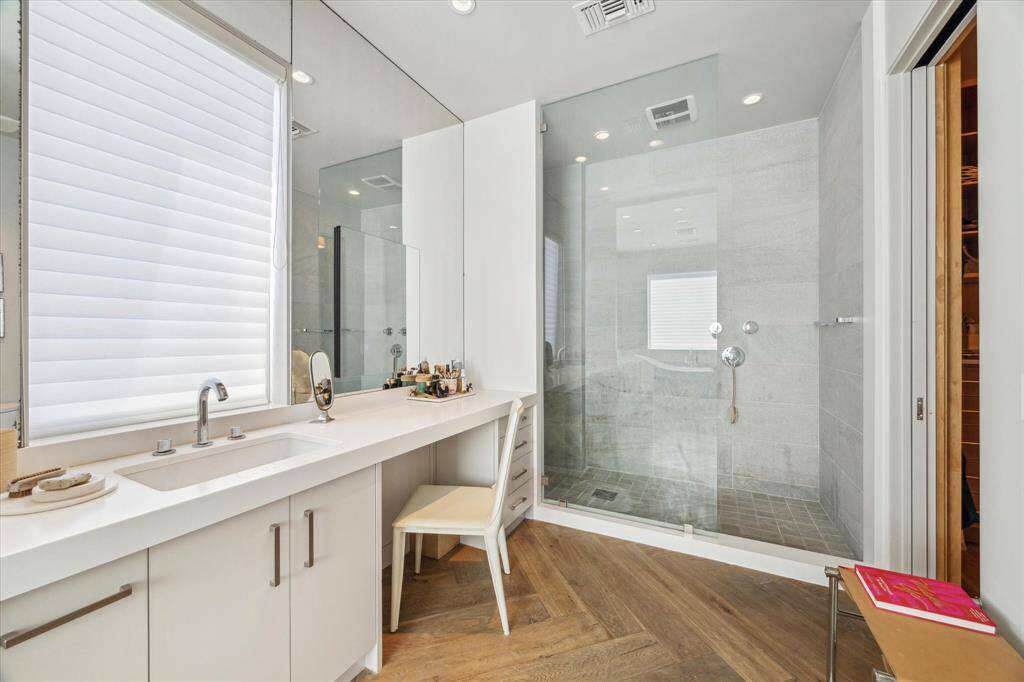 The first primary bedroom closet has built-in storage, created to hold a multiplicity of the same outfit or curated looks for the fashion enthusiast.