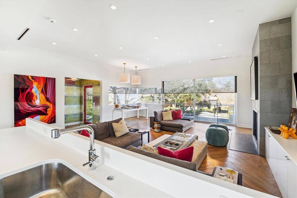 Picture yourself enjoying a refreshment on this elevated covered patio designed for entertaining, complete with integrated speakers. Having this extra wide covered porch greatly increases your living space. The north elevation and being raised a level, allows you to enjoy the breezes.  Guess what? Minimal bugs!