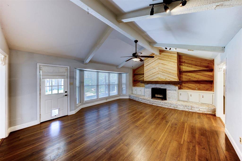 Living room with access to the back covered patio and yard