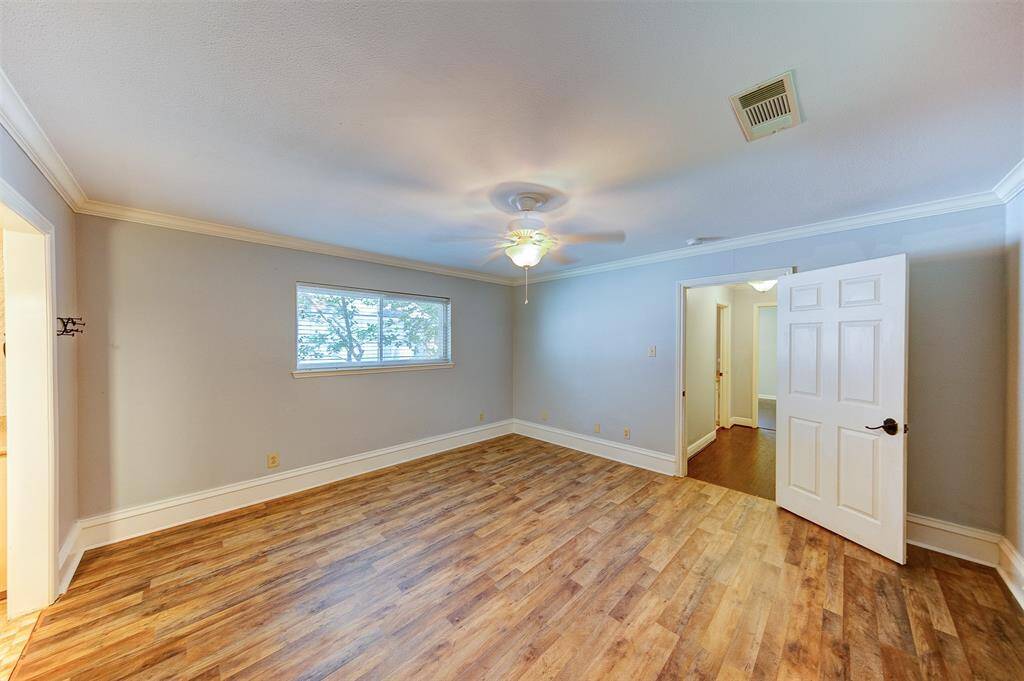 Primary bedroom with new laminate flooring