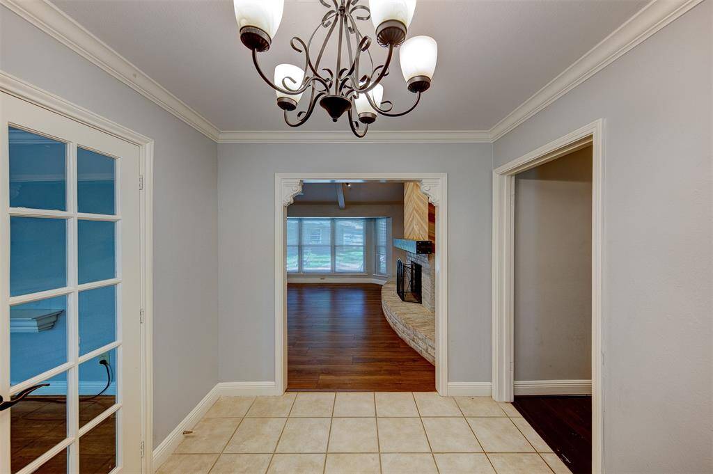 Front entry leads directly into the living room. On the left, through the french doors is a formal living/office/flex room leading into the formal dining room and into the kitchen that opens up into the living room. To the right is the hallway to all of the bedrooms.