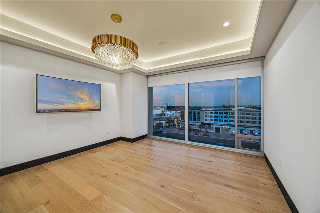 This primary bedroom comes equipped with a 75" curved TV for your viewing pleasure!