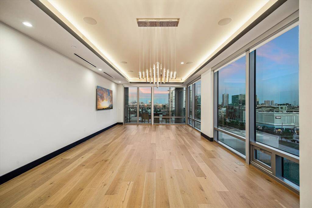 This corner condo in a luxury high-rise offers stunning panoramic views and an expansive, elegant living space.