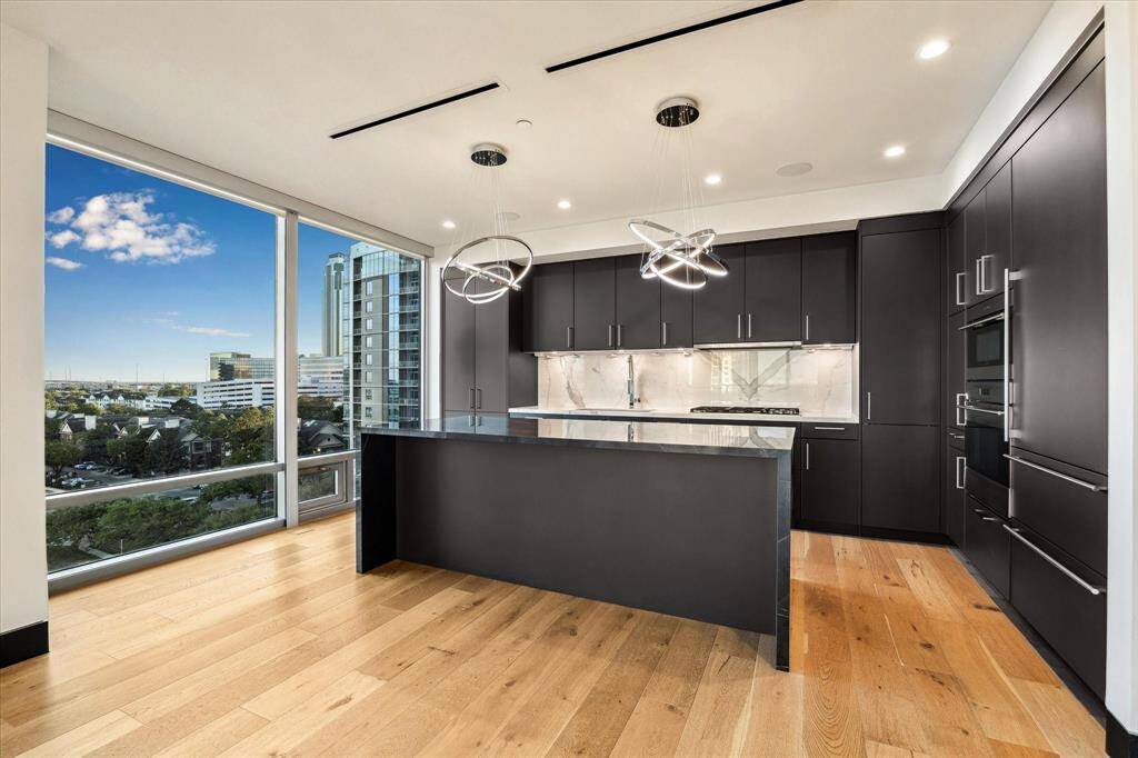 This open-concept luxury kitchen features sleek custom cabinetry, high-end appliances, and a spacious island perfect for both everyday living and elegant entertaining.