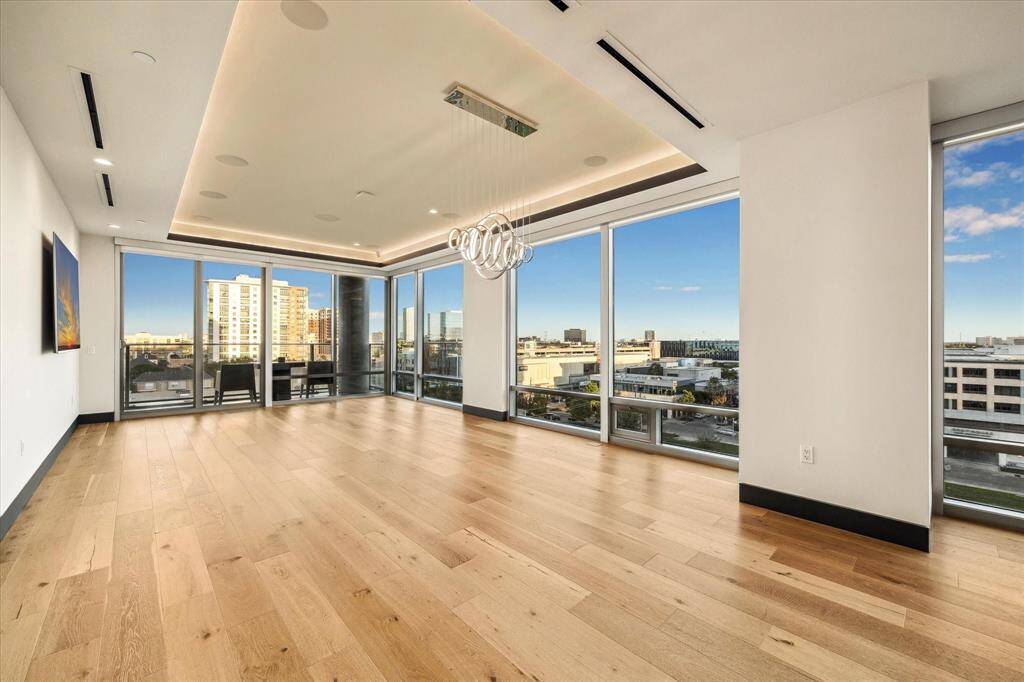 This corner condo in a luxury high-rise offers stunning panoramic views and an expansive, elegant living space.