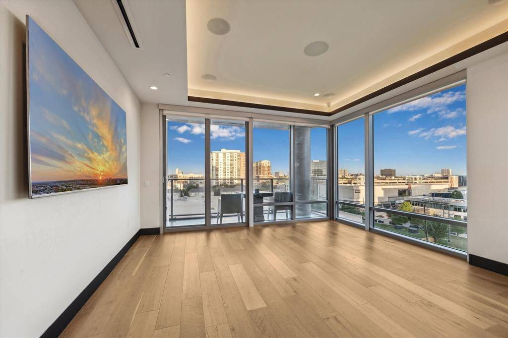 Bask in stunning floor-to-ceiling windows that flood the room with natural light and open to a private balcony with sweeping views of Houston.