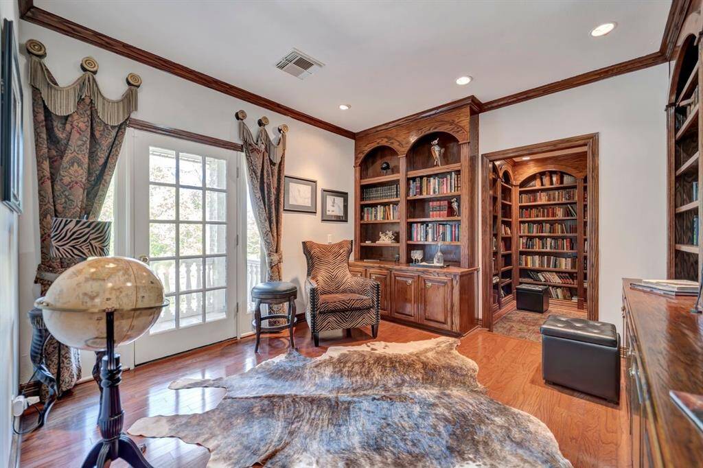 Hardwood paneled library with private balcony.