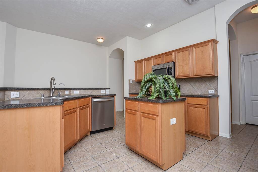 Lots of cabinet space, granite counter tops, island w/ storage space, stainless steel appliances.