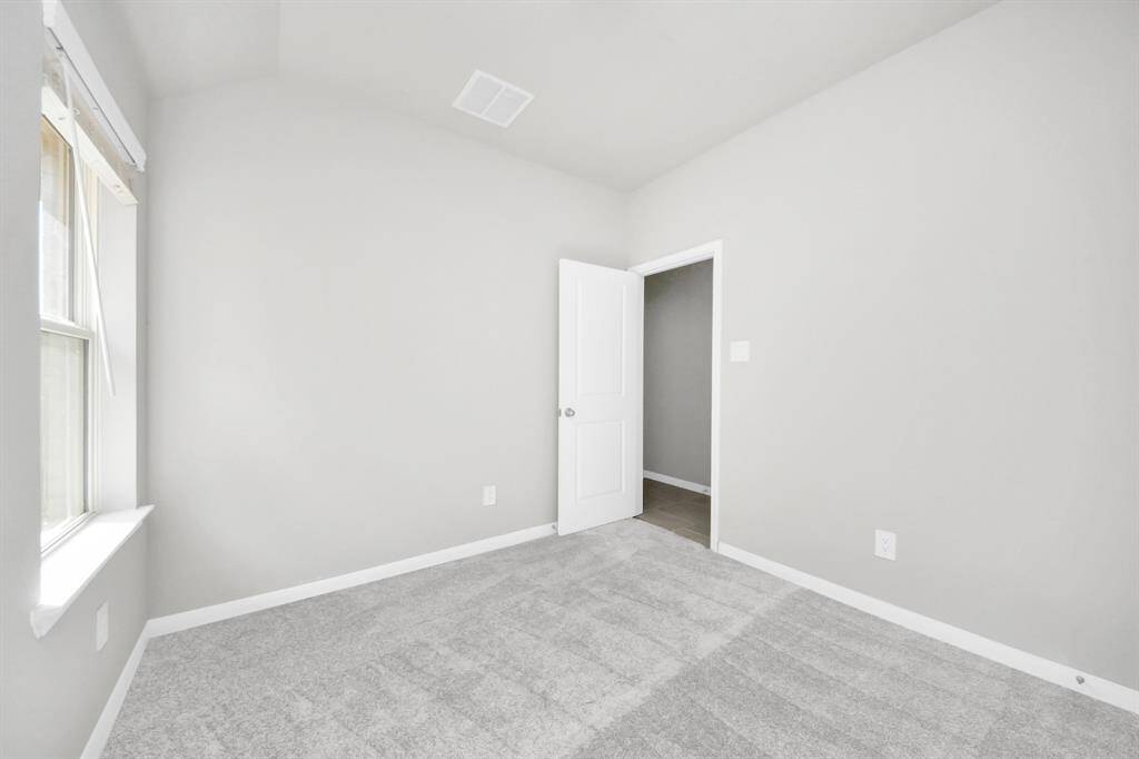 Generously sized secondary bedrooms featuring spacious closets, soft and inviting carpeting underfoot, large windows allowing plenty of natural light, and the added touch of privacy blinds for your personal retreat.