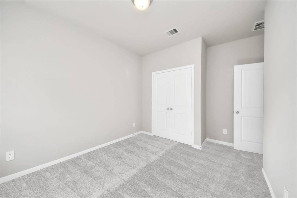 Generously sized secondary bedrooms featuring spacious closets, soft and inviting carpeting underfoot, large windows allowing plenty of natural light, and the added touch of privacy blinds for your personal retreat.