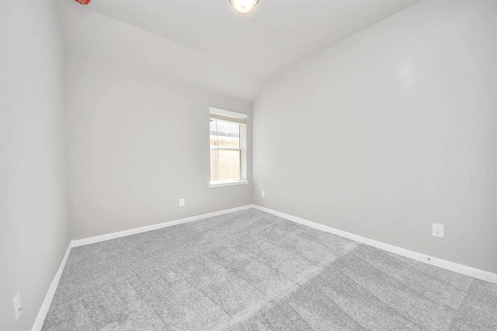 Secondary bedroom features plush carpeting, large windows that let in plenty of natural light, bright paint, and spacious closets.