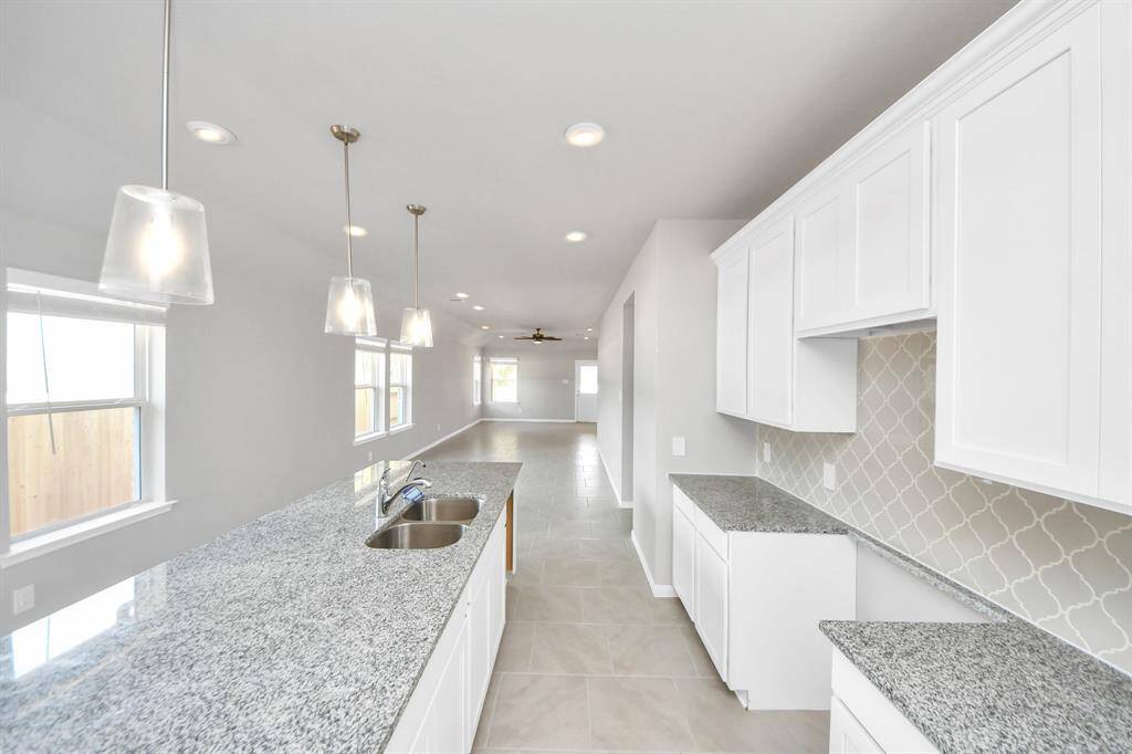 All of this overlooks your expansive family room, creating a perfect space for culinary delights and family gatherings.