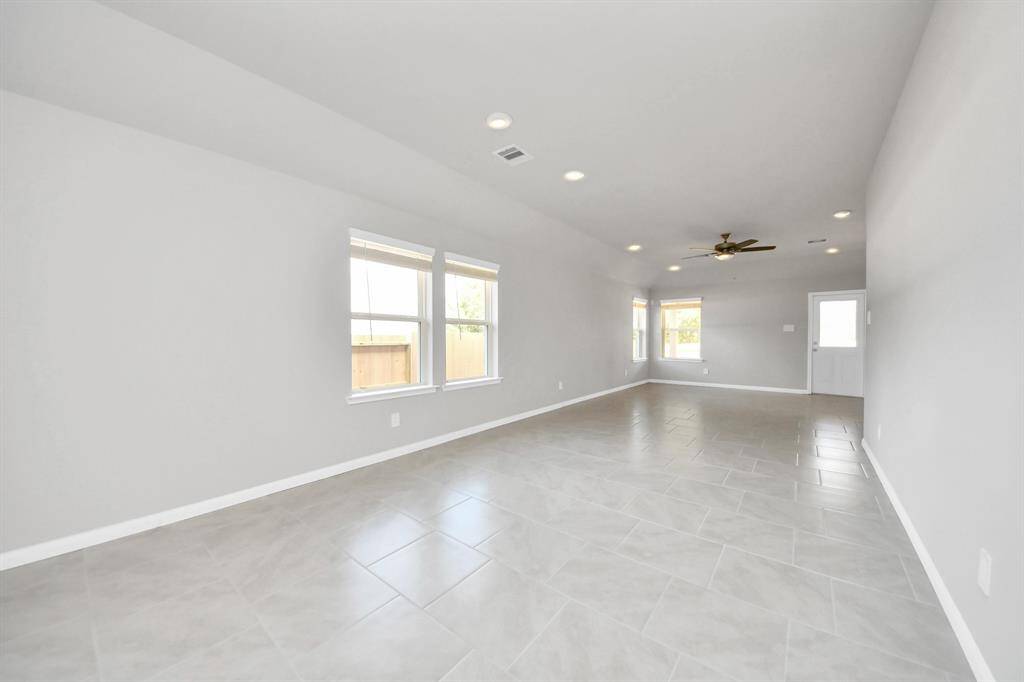 Create lasting memories with your family and friends at the dining table! This expansive dining room showcases sophisticated flooring, custom paint, and seamlessly connects to the family room and kitchen, providing an open and inviting atmosphere