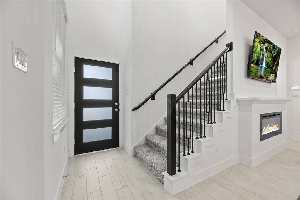 Another view of the front entry. Beautiful wrought iron staircase.