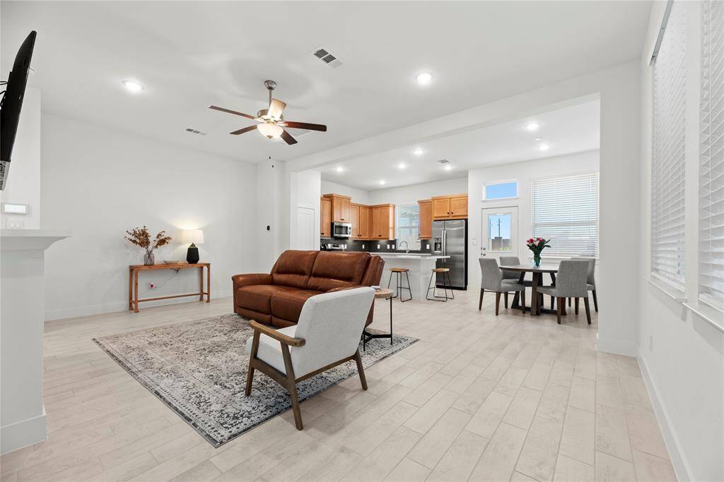 Nice, open floor plan. Neutral paint color and gorgeous wood-look tile flooring.