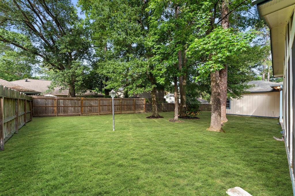 Spacious yard with trees for plenty of shade. (Grass enhanced for photo)