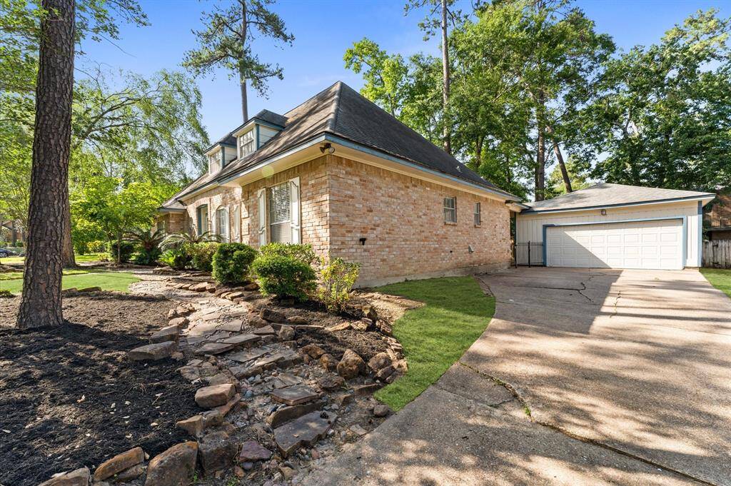 Side of driveway provides stepping stones to front entry. Driveway widens to a double wide at the Detached 2 car garage.
