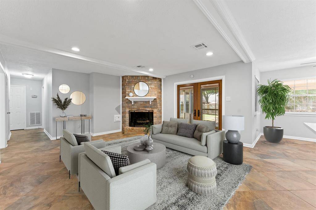 French doors open to the screened-in back patio, offering a perfect transition between indoor and outdoor living.