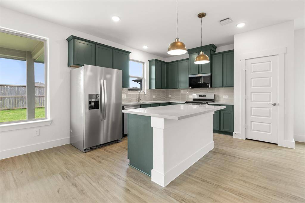 This beautiful brand new kitchen boasts stunning cabinetry that stretches to the ceiling, offering both style and ample storage for all your culinary treasures.