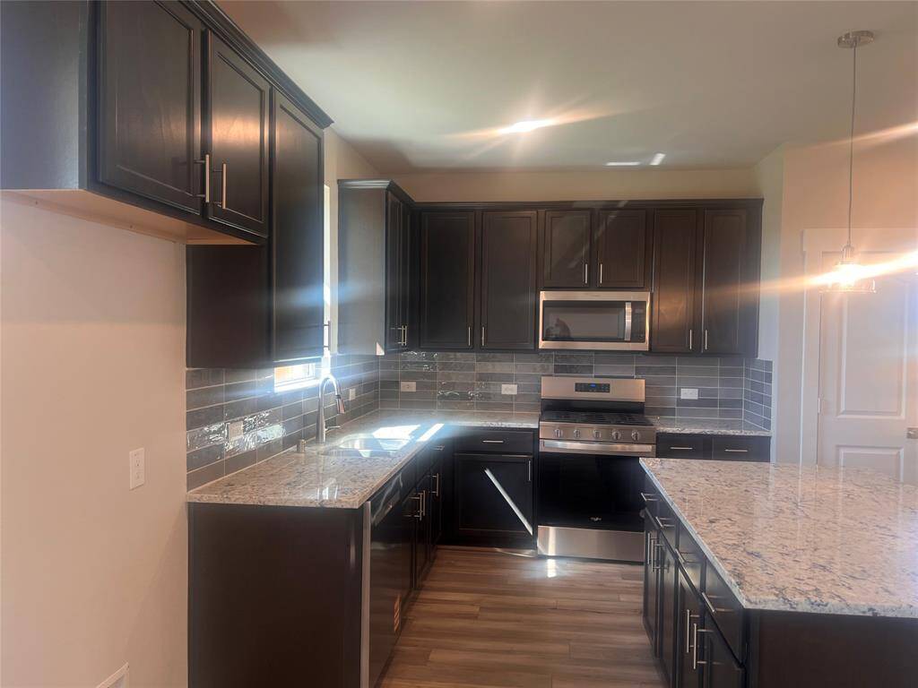 This beautiful brand new kitchen boasts stunning cabinetry that stretches to the ceiling, offering both style and ample storage for all your culinary treasures.