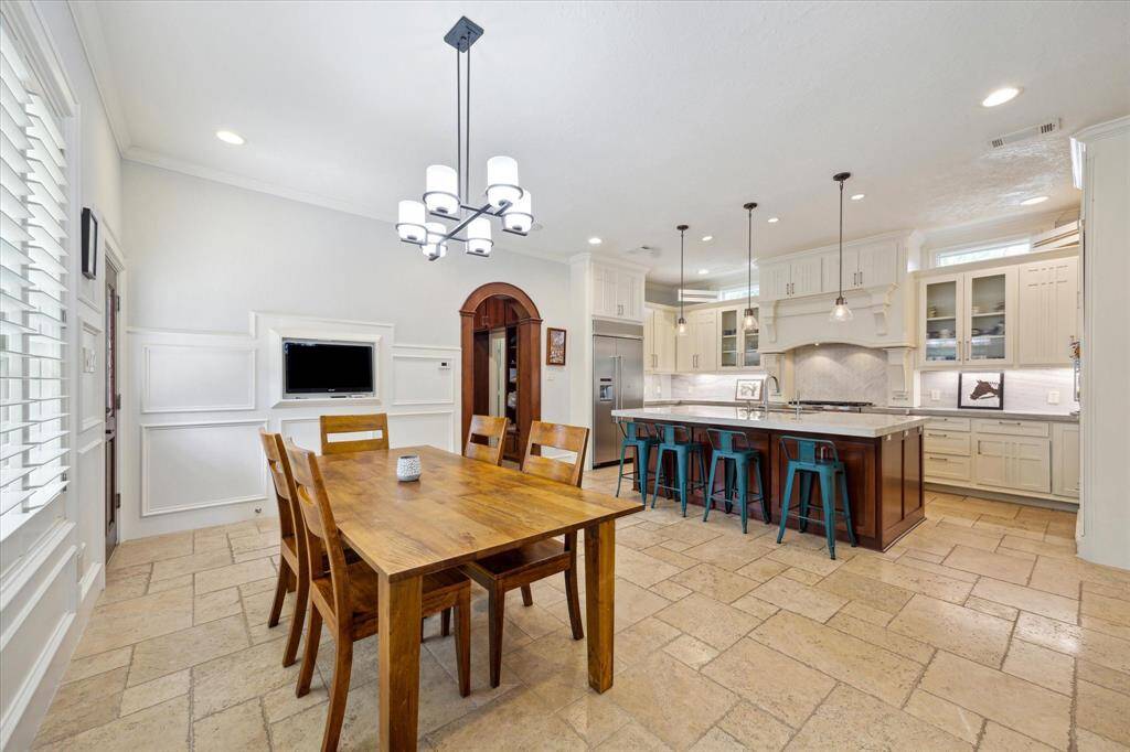 An alternative view of the dining room/kitchen. Built-in TV.