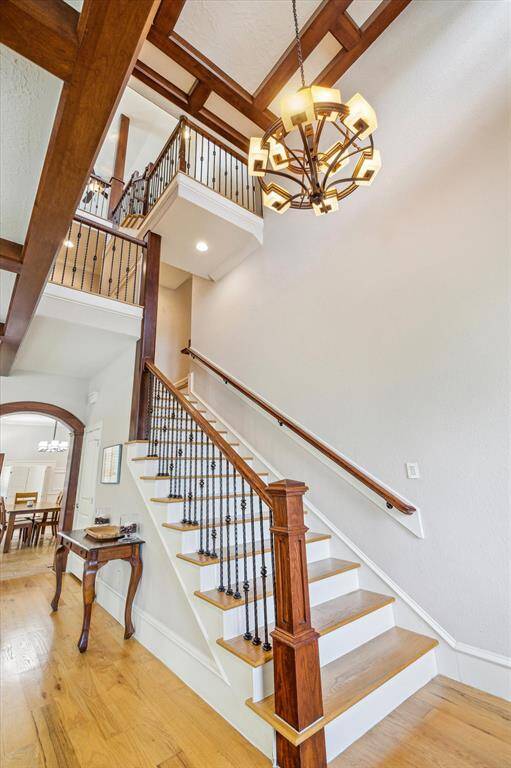 The staircase is a true statement piece, featuring soaring ceilings and a stunning large chandelier that adds a touch of elegance to the space.