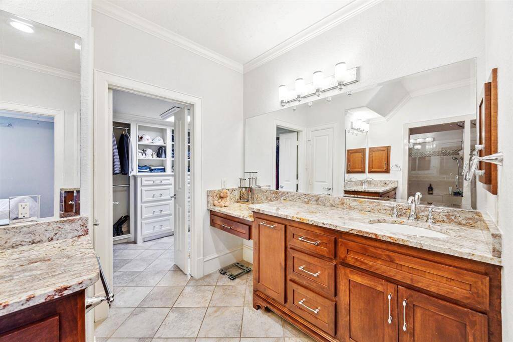 An alternative view of the primary bathroom. Large walk-in closet with built-in drawers.