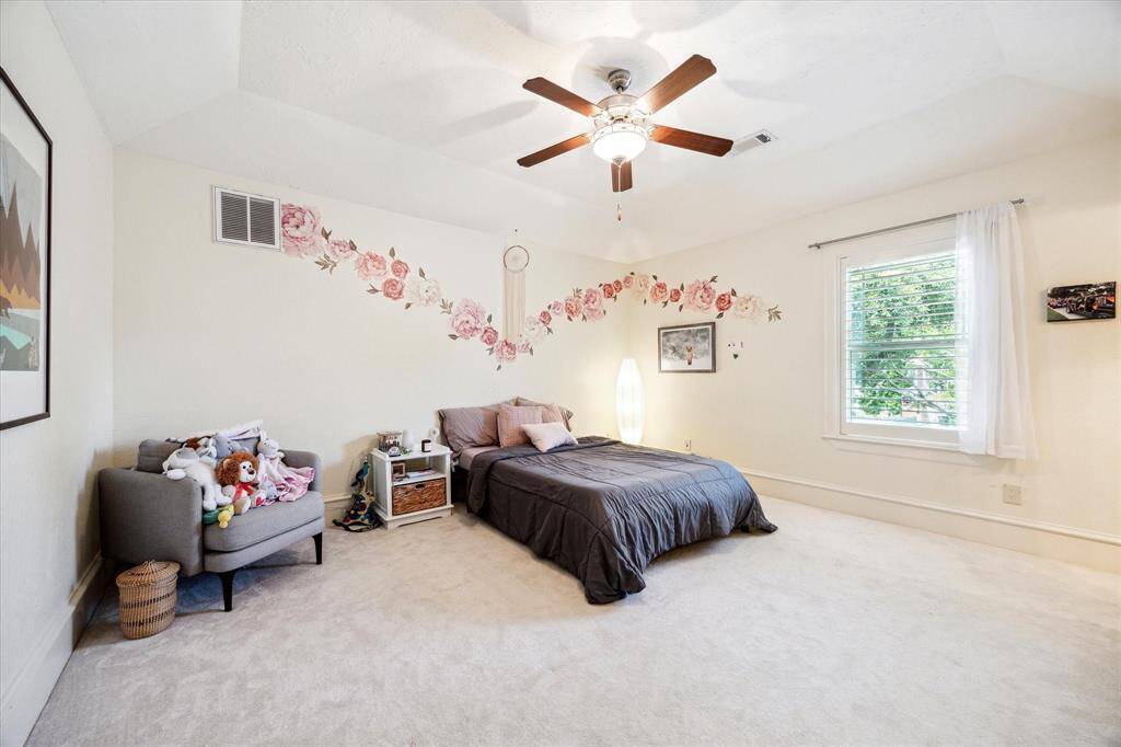 [One of the four guest bedrooms] All guest bedrooms are generously sized. This one features vaulted ceilings and a private en-suite bathroom for added comfort and privacy.