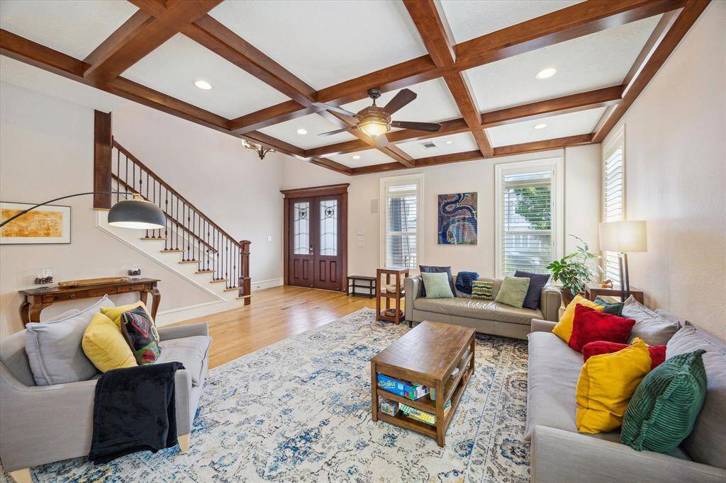 [Family Room] This stunning family room impresses with soaring coffered ceilings framed with rich wooden beams