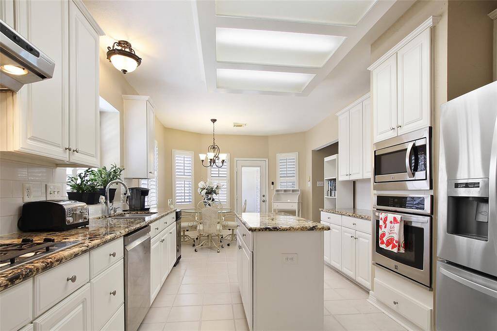 Updated Gourmet Kitchen with gorgeous granite countertops, white cabinets and stainless steel appliances.
