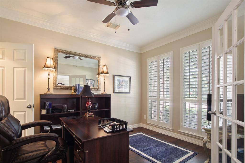 Home Office/Study with Plantation Shutters and French Doors with a door to the hallway.