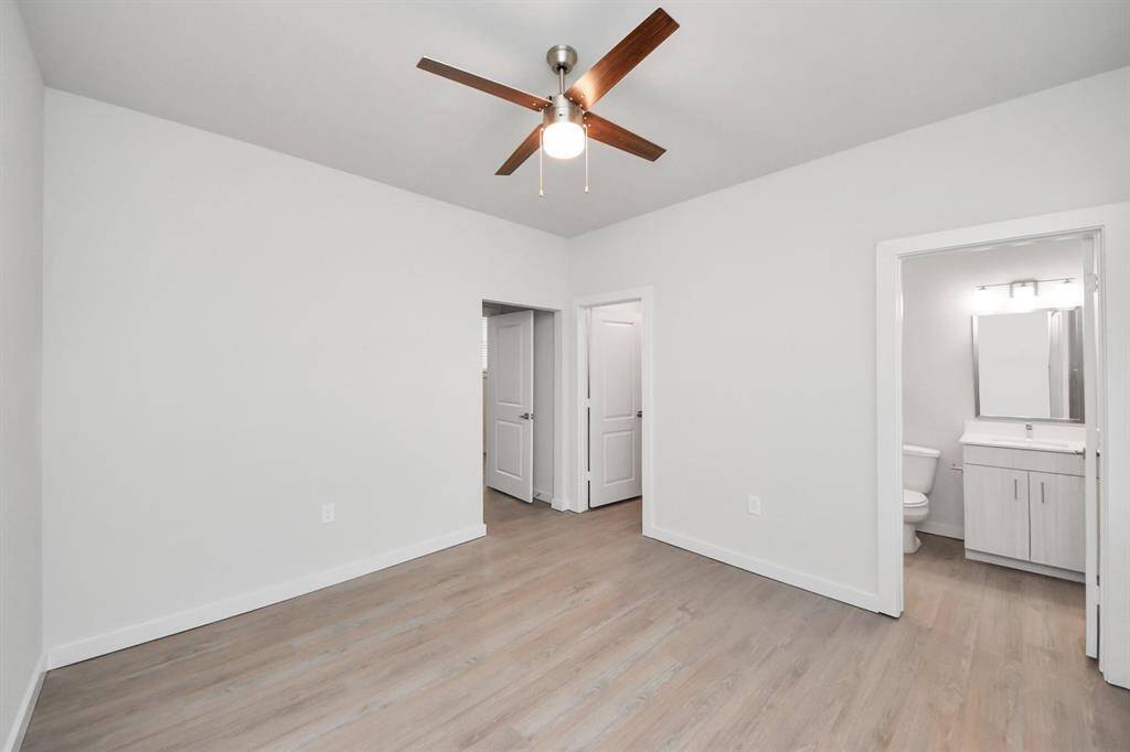 Secondary Bedroom with wood-like floors, closet and ensuite full bath with tub/shower combo.