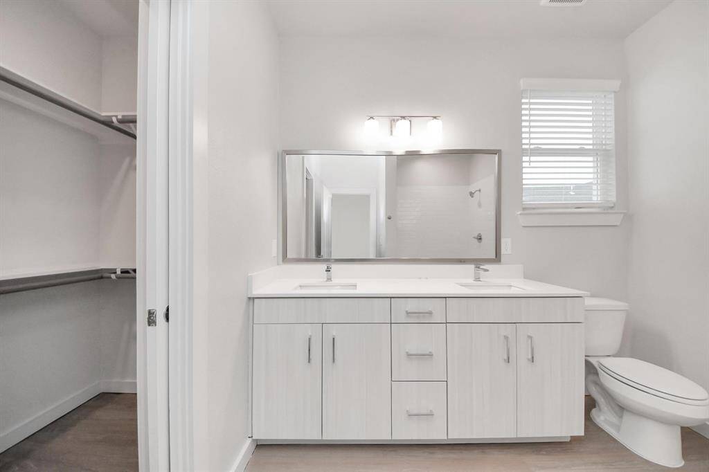 Spacious Owner’s retreat with wood-like floors, walk-in closet and spa-like bath w/dual sinks.
