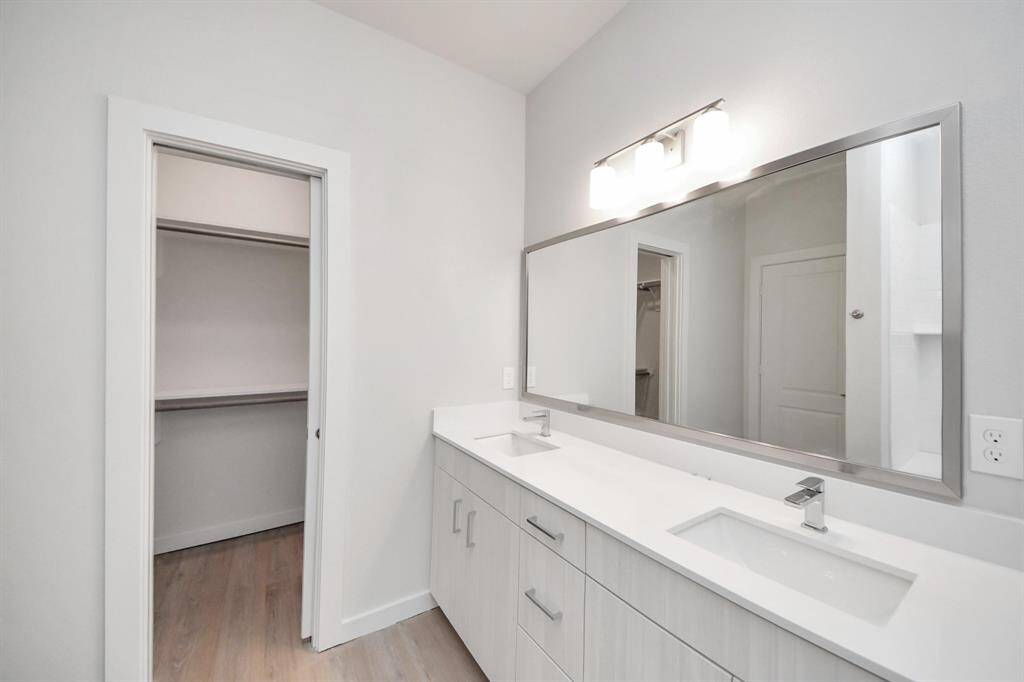 Spacious Owner’s retreat with wood-like floors, walk-in closet and spa-like bath w/dual sinks.