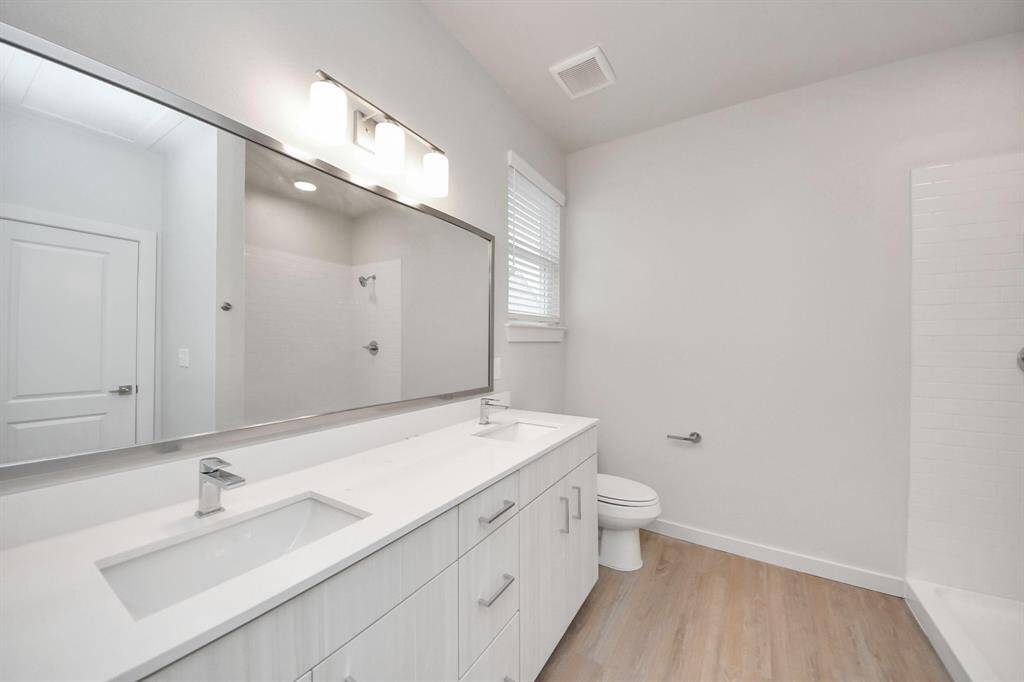 Spacious Owner’s retreat with wood-like floors, walk-in closet and spa-like bath w/dual sinks.