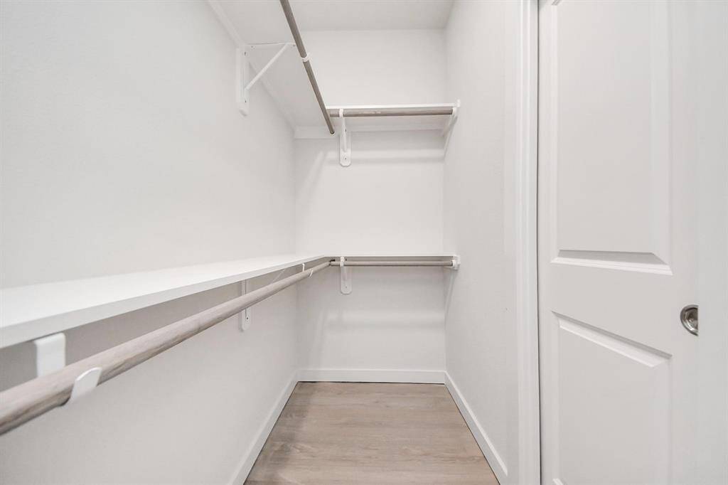 Spacious Owner’s retreat with wood-like floors, walk-in closet and spa-like bath w/dual sinks.
