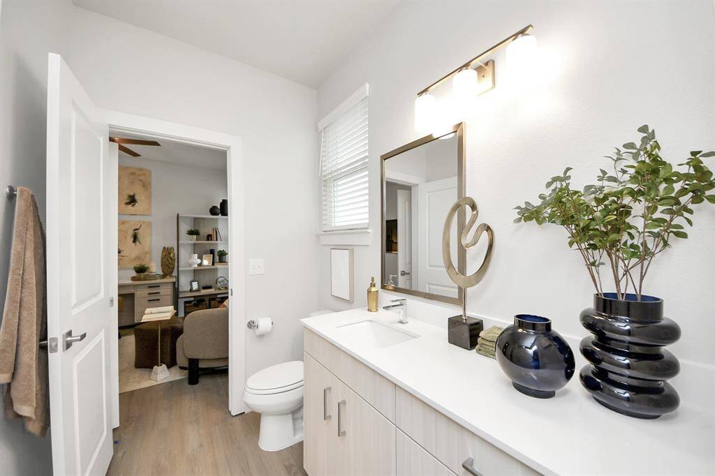 Full secondary bathroom with tub/shower combo and vanity area.