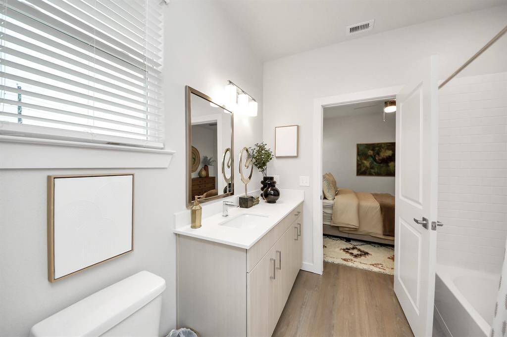 Full secondary bathroom with tub/shower combo and vanity area.