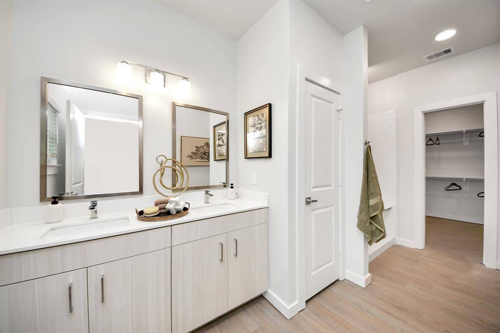 Spacious Owner’s retreat with wood-like floors, walk-in closet and spa-like bath w/dual sinks.