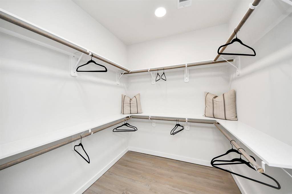 Spacious Owner’s retreat with wood-like floors, walk-in closet and spa-like bath w/dual sinks.