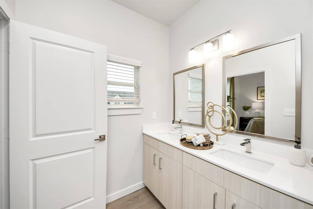Spacious Owner’s retreat with wood-like floors, walk-in closet and spa-like bath w/dual sinks.