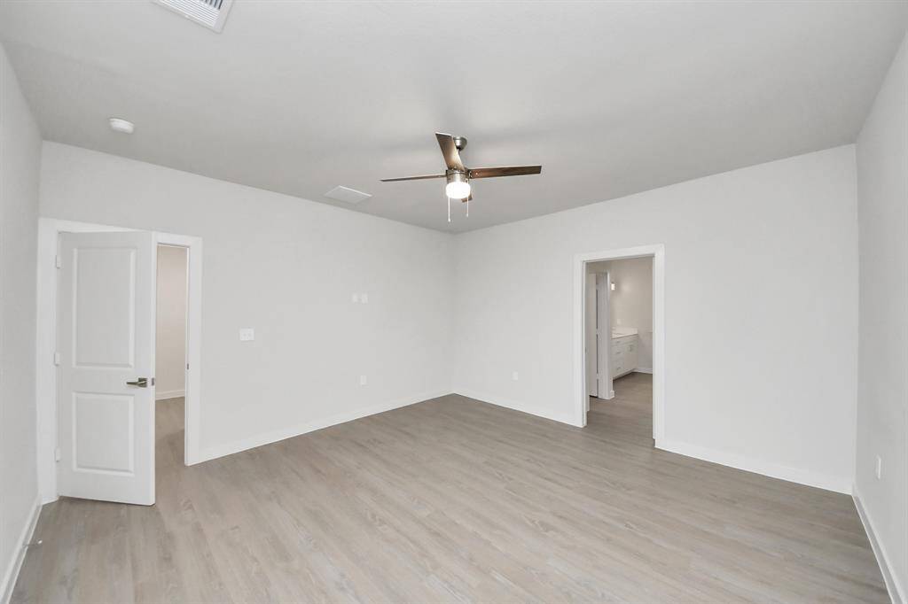 Spacious Owner’s retreat with wood-like floors, walk-in closet and spa-like bath w/dual sinks.
