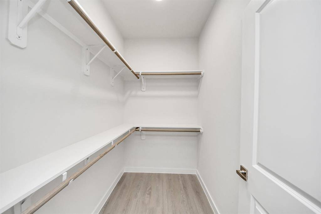 Spacious Owner’s retreat with wood-like floors, walk-in closet and spa-like bath w/dual sinks.
