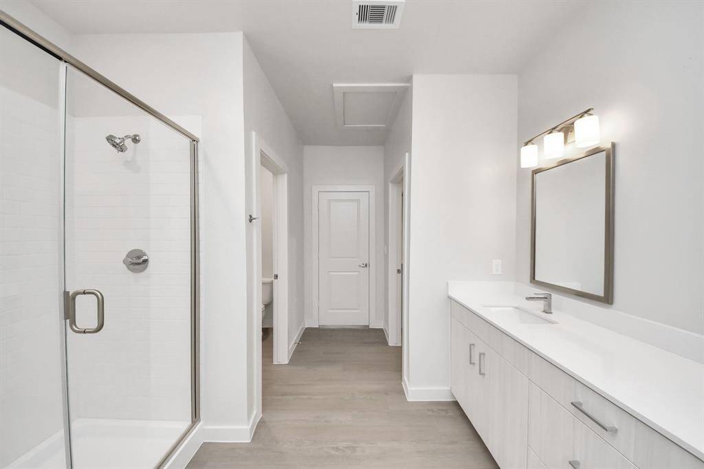 Spacious Owner’s retreat with wood-like floors, walk-in closet and spa-like bath w/dual sinks.
